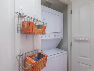 a laundry room with a washing machine and a basket at Rosenberg Slide Creek Reduced Nightly Rate in Bass Lake