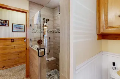a bathroom with a shower with a glass door at Wilts Happy Place in Bass Lake