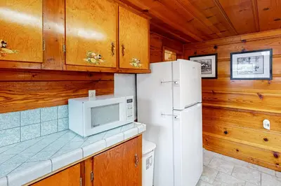 a kitchen with a refrigerator and a microwave at Wilts Happy Place in Bass Lake