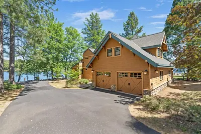 a house with a garage on a driveway at Marina Beach Lodge - Lakefront Home on Beach! home in Groveland