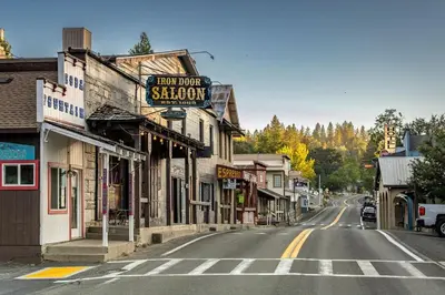 an empty street in a small town with a sign for a shop at Marina Beach Lodge - Lakefront Home on Beach! home in Groveland