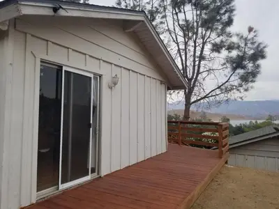 a large wooden deck next to a house at 3BR Panoramic Lake View, Sequoia Forest, Kern County in Wofford Heights