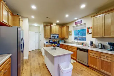 a kitchen with wooden cabinets and stainless steel appliances at Charming Mt Rose Retreat in South Lake Tahoe