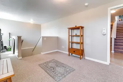 an empty living room with a wooden shelf and stairs at Furnished Deck and Gas Grill South Lake Tahoe Home! in South Lake Tahoe