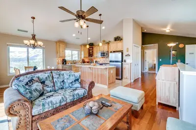 a living room with a couch and a table at Furnished Deck and Gas Grill South Lake Tahoe Home! in South Lake Tahoe