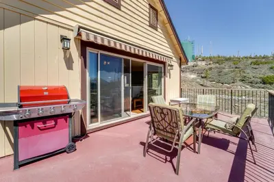 a patio with a grill and a table and chairs at Furnished Deck and Gas Grill South Lake Tahoe Home! in South Lake Tahoe