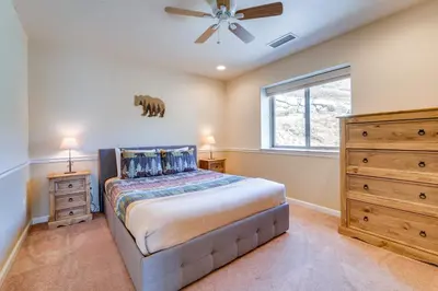 a bedroom with a bed and a ceiling fan at Furnished Deck and Gas Grill South Lake Tahoe Home! in South Lake Tahoe