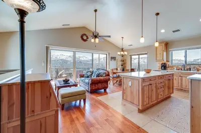 a kitchen and living room with a couch and a table at Furnished Deck and Gas Grill South Lake Tahoe Home! in South Lake Tahoe