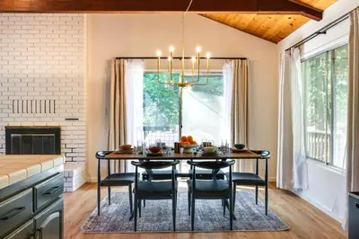 a kitchen and dining room with a table and chairs at Deck and Fire Pit Stunning Twain Harte Cabin! in Twain Harte