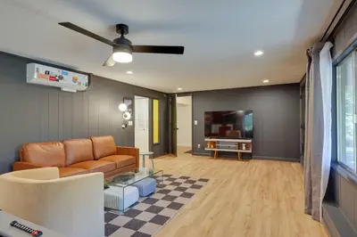 a living room with a couch and a tv at Deck and Fire Pit Stunning Twain Harte Cabin! in Twain Harte