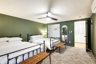 a room with three beds and benches in it at Deck and Fire Pit Stunning Twain Harte Cabin! in Twain Harte