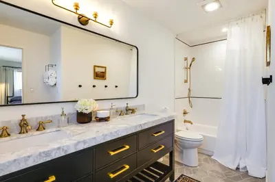 a bathroom with a sink and a toilet and a mirror at Deck and Fire Pit Stunning Twain Harte Cabin! in Twain Harte