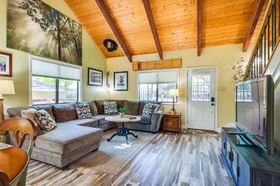 a living room with a couch and a tv at Groveland Home - Walk to Pine Mountain Lake! in Groveland