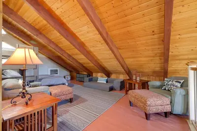 a living room with a wooden ceiling with beams at Groveland Home - Walk to Pine Mountain Lake! in Groveland