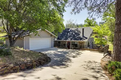 a house with a driveway and a garage at Groveland Home - Walk to Pine Mountain Lake! in Groveland