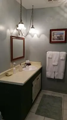 a bathroom with a sink and a mirror at The Parks Inn in Three Rivers