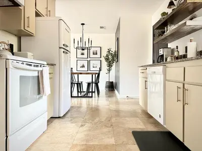 a kitchen with white appliances and a table at Prime location Yosemite Expedition by Casa Oso in Oakhurst