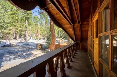a porch of a cabin with a view of the woods at 3BR Mountain Cabin-Near Beach & Slopes in Homewood