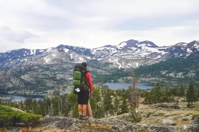 a person standing on top of a mountain looking at the mountains at 3BR Mountain Cabin-Near Beach & Slopes in Homewood