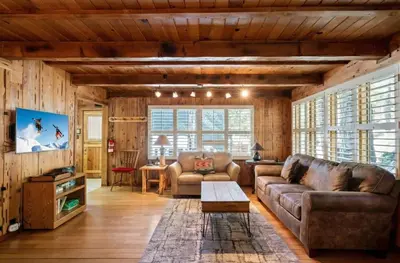 a living room with a couch and a table at 3BR Mountain Cabin-Near Beach & Slopes in Homewood