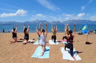 a group of people doing yoga on the beach at Lakeside Studio Steps from the Beach in Tahoe Vista