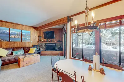 a living room with a table and a couch at Mountain Time Escape in Olympic Valley