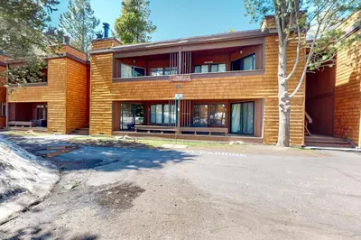 a large brick building with a tree in front of it at Mountain Time Escape in Olympic Valley