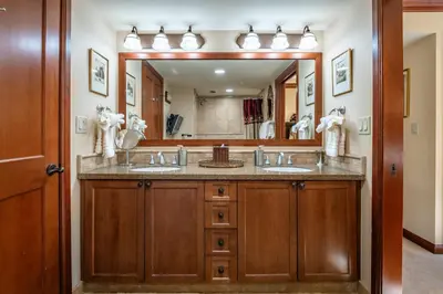 a bathroom with two sinks and a large mirror at Everline Resort & Spa 701 & 703 in Olympic Valley
