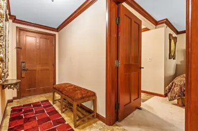 a room with a wooden door and a stool at Everline Resort & Spa 701 & 703 in Olympic Valley