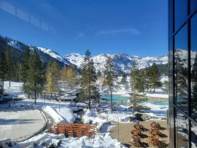 a view of a snow covered mountain from a window at Everline Resort & Spa 701 & 703 in Olympic Valley