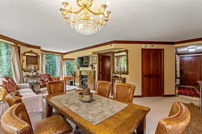 a dining room with a table and chairs and a chandelier at Everline Resort & Spa 701 & 703 in Olympic Valley