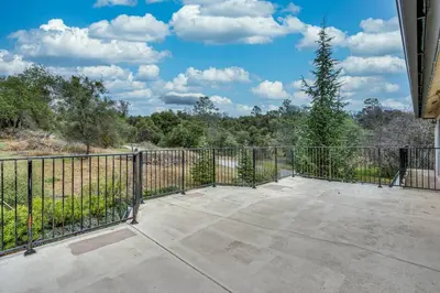 a large patio with a fence and a tree at Yosemite South Presidential Mansion in Coarsegold