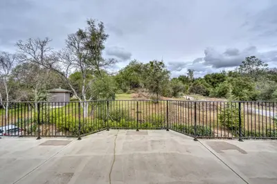 a large black fence with a concrete patio at Yosemite South Presidential Mansion in Coarsegold