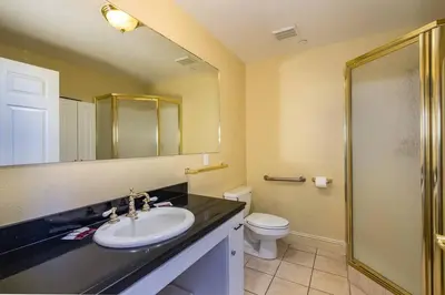 a bathroom with a sink and a toilet and a shower at Yosemite South Presidential Mansion in Coarsegold