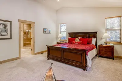 a bedroom with a large bed with red pillows at Tahoe Discovery in South Lake Tahoe