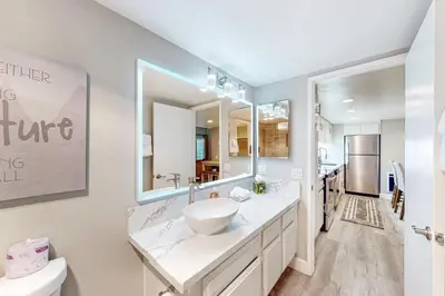 a bathroom with a sink and a large mirror at Mountain Shadows H6 in Mammoth Lakes
