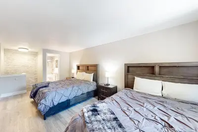 a hotel room with two beds and a night stand at Mountain Shadows H6 in Mammoth Lakes