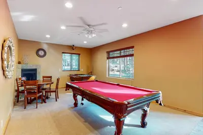 a room with a pool table and a dining room at Heavenly Lake Hideaway in South Lake Tahoe