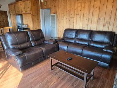 a leather couch and a coffee table in a living room at Lake Isabella View, Wofford Heights, Kern County in Wofford Heights