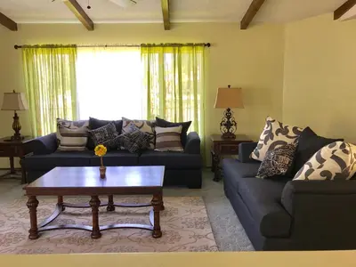 a living room with two couches and a coffee table at The River Inn in Three Rivers
