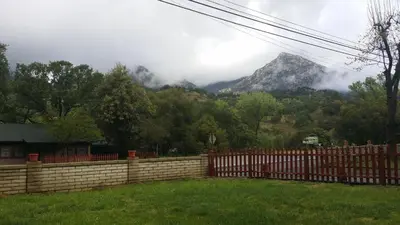a fence in a yard with a mountain in the background at The River Inn in Three Rivers