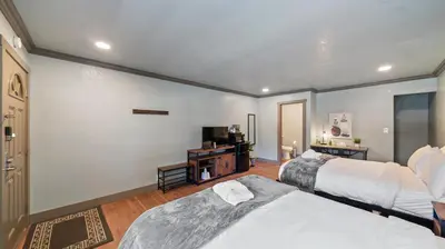 a hotel room with two beds and a television at Blue Jay Lodge in South Lake Tahoe