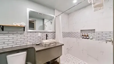 a white bathroom with a sink and a toilet at Blue Jay Lodge in South Lake Tahoe