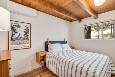 a bedroom with a bed and a window at Marina Beach Cabin - Dog-Friendly Home with Deck! home in Groveland