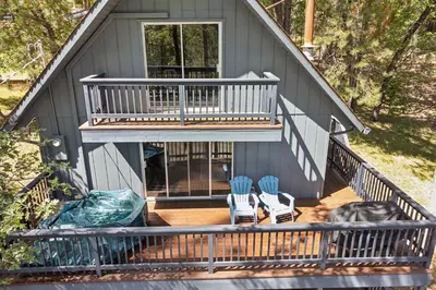 a screened in porch with two chairs and a house at Marina Beach Cabin - Dog-Friendly Home with Deck! home in Groveland
