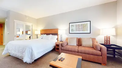 a hotel room with a bed and a couch at Village Monache #309 condo in Mammoth Lakes