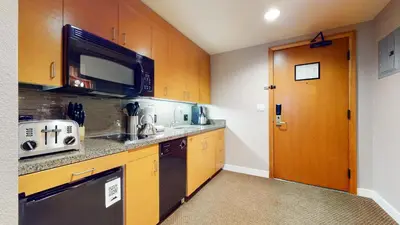 a small kitchen with a sink and a microwave at Village Monache #309 condo in Mammoth Lakes