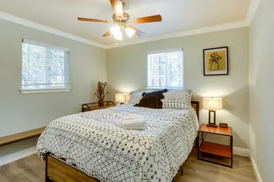 a black cat laying on a bed in a bedroom at Welcoming South Lake Tahoe Rental Near Beaches in South Lake Tahoe