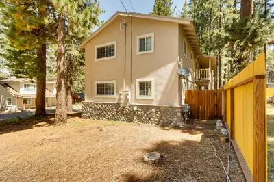 a house with a fence in front of it at Welcoming South Lake Tahoe Rental Near Beaches in South Lake Tahoe