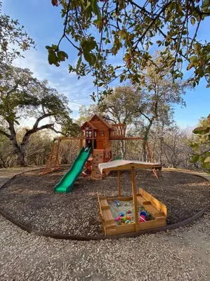 a playground with a slide and a play structure at Modern House on 5 acr in Sequoia National Forest in Panorama Heights
